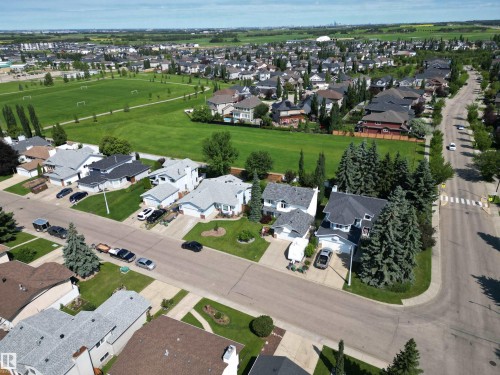 Residential neighborhood featuring diverse architectural styles, asphalt streets, and verdant green spaces - 5604 57 Avenue, Beaumont, AB 