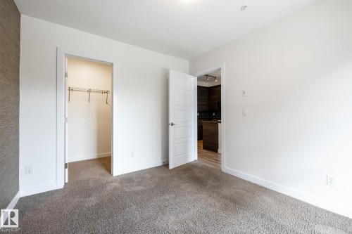 Neutral tone-on-tone carpeting - #215 2590 Anderson Wy Sw, Edmonton, AB - Indoor