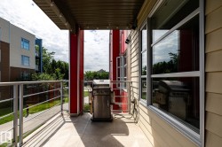 Private outdoor balcony with glass panel railing and composite decking - 
