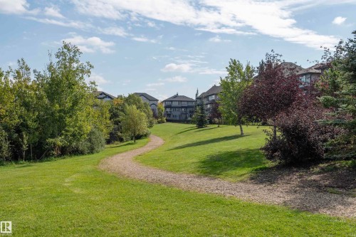 Expansive green space featuring a winding gravel pathway - #215 2590 Anderson Wy Sw, Edmonton, AB - Outdoor With View