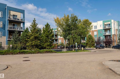 Modern multi-story apartment buildings featuring private balconies with glass railings - #215 2590 Anderson Wy Sw, Edmonton, AB - Outdoor With Facade