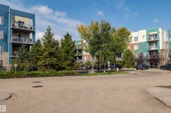 Modern multi-story apartment buildings featuring private balconies with glass railings - 