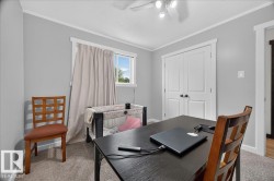 Neutral gray walls featuring white trim and a window with natural light - 