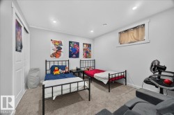 Carpeted room featuring a window with white trim, recessed lighting, and a double-door closet - 