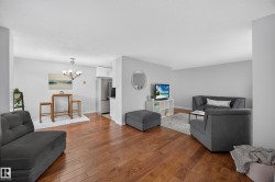 Open-concept living space with wood-finish flooring throughout - 