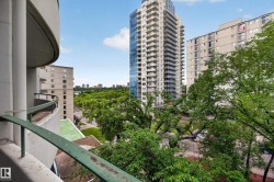 Curved balcony railing offering a high-level perspective of the surrounding urban environment - 