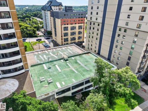 Multi-story parking structure with a rooftop area and surrounding mature trees - #602 9725 106 St Nw, Edmonton, AB 