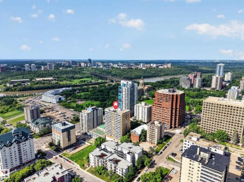 Urban landscape featuring a prominent river, expansive green spaces, and a diverse collection of high-rise buildings under a clear sky - #602 9725 106 St Nw, Edmonton, AB 