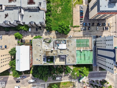 Rooftop amenity space featuring a tennis court, green turf areas, and structured outdoor seating - #602 9725 106 St Nw, Edmonton, AB 