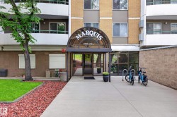 Building entrance featuring a curved glass awning and prominent signage - 