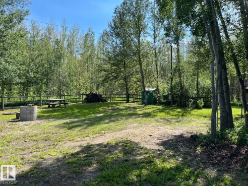 Grassed clearing surrounded by mature deciduous trees - 4701 34 St., Rural Wetaskiwin County, AB 
