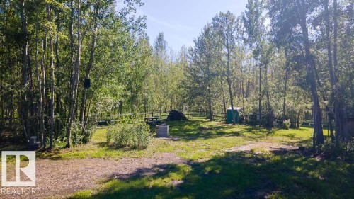 Wooded parcel featuring mature deciduous trees and a clearing with a fire pit - 4701 34 St., Rural Wetaskiwin County, AB 