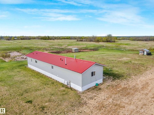 Single-story property with light gray siding and a red metal roof - 57016 Range Road 13, Rural Barrhead County, AB - Outdoor With View