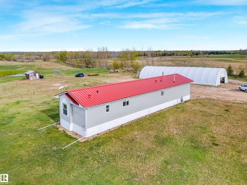 Single-story structure featuring a red metal roof and light grey siding - 57016 Range Road 13, Rural Barrhead County, AB - Outdoor