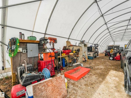Large arched structure with a white canvas roof, exposed metal framing, and a gravel floor - 57016 Range Road 13, Rural Barrhead County, AB - Indoor Photo Showing Other Room