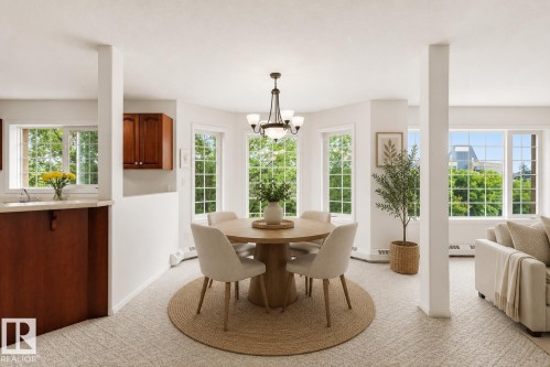 Bright dining area featuring a chandelier, a neutral color palette, and extensive window-framing with grid patterns - #201 14 Mission Av, St. Albert, AB - Indoor Photo Showing Dining Room