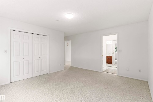 Spacious interior room featuring light-toned carpeting and white walls - #201 14 Mission Av, St. Albert, AB - Indoor