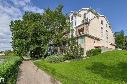 Multi-level residential building featuring stucco and brick exterior finishes, multiple balconies, and abundant natural light from numerous windows - #201 14 Mission Av, St. Albert, AB - Outdoor