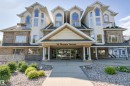Multi-story residential building featuring a stone and siding exterior - #201 14 Mission Av, St. Albert, AB  - Outdoor With Facade 