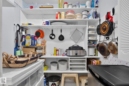 Organized pantry featuring multiple open shelving units and integrated vertical storage - 12703 122 Street Nw, Edmonton, AB 