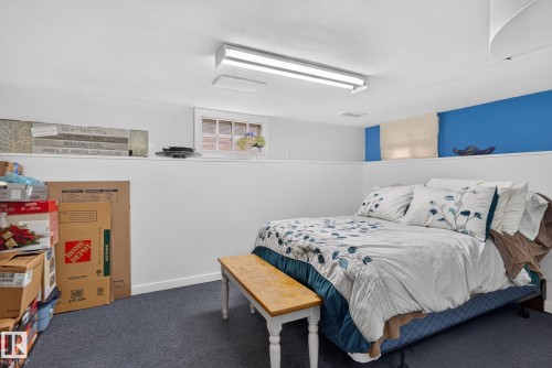 Carpeted floor with white walls and a partial blue accent wall - 12703 122 Street Nw, Edmonton, AB 