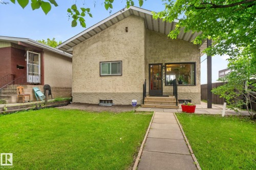 Stucco exterior with a peaked metal roofline - 12703 122 Street Nw, Edmonton, AB 