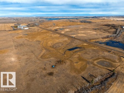 Expansive acreage featuring a long private road, multiple natural water features, and a distant building cluster - 0 Ne-3-56-12-W4 Northeast, Rural Two Hills County, AB 