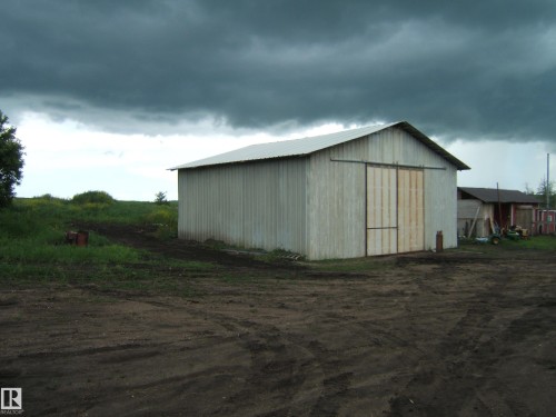 Corrugated metal barn structure with a pitched metal roof and large sliding barn doors - 543016 Rng Rd 122, Rural Two Hills County, AB - Outdoor