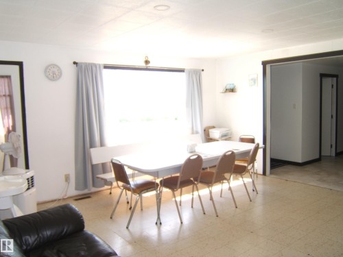 Dining area with large window and light-toned flooring - 543016 Rng Rd 122, Rural Two Hills County, AB - Indoor Photo Showing Dining Room