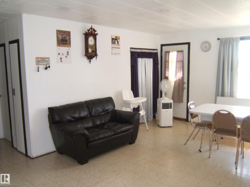 Bright interior space with light-colored tile flooring - 543016 Rng Rd 122, Rural Two Hills County, AB - Indoor Photo Showing Other Room