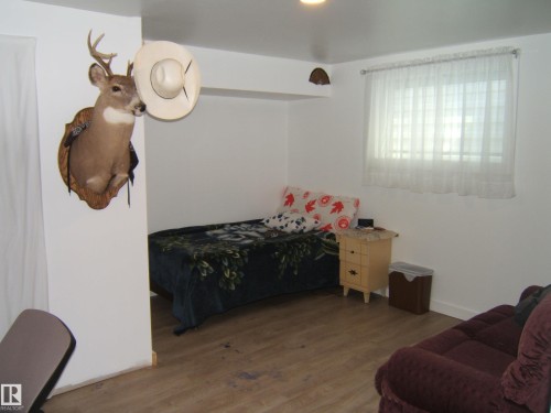 Room with wood-finish flooring, white walls, and a recessed light fixture - 543016 Rng Rd 122, Rural Two Hills County, AB - Indoor Photo Showing Bedroom
