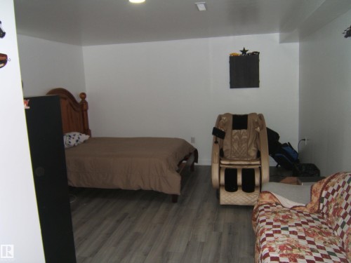 Room featuring light wood-finish flooring, white painted walls, and recessed ceiling lighting - 543016 Rng Rd 122, Rural Two Hills County, AB - Indoor Photo Showing Bedroom
