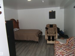 Room featuring light wood-finish flooring, white painted walls, and recessed ceiling lighting - 