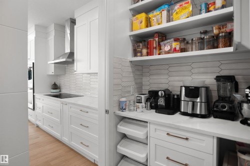 White shaker cabinetry and light wood-finish flooring - 5802 Soleil Boulevard, Beaumont, AB 