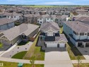 Modern suburban residence featuring a multi-tone exterior, attached double garage, and a concrete driveway - 5802 Soleil Boulevard, Beaumont, AB 