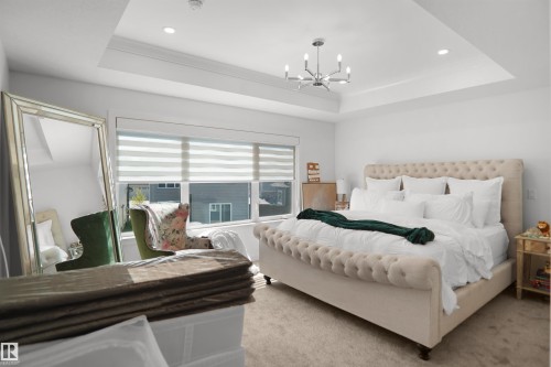 Tray ceiling with recessed lighting and a contemporary chandelier - 5802 Soleil Boulevard, Beaumont, AB 