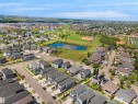 Aerial overview showcasing a residential development with varied housing styles - 5802 Soleil Boulevard, Beaumont, AB 