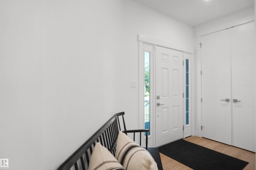 Entryway featuring a paneled door with side lights, light wood-finish flooring, and recessed ceiling lighting - 5802 Soleil Boulevard, Beaumont, AB 