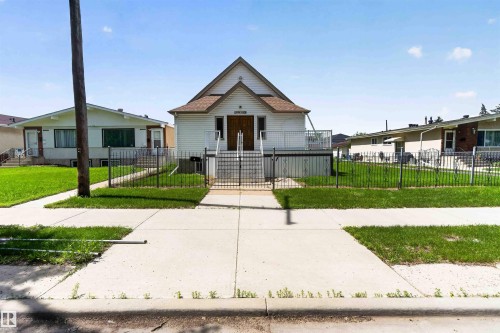 Gabled facade with white siding and a brown shingle roof - 13156 101 St Nw, Edmonton, AB 