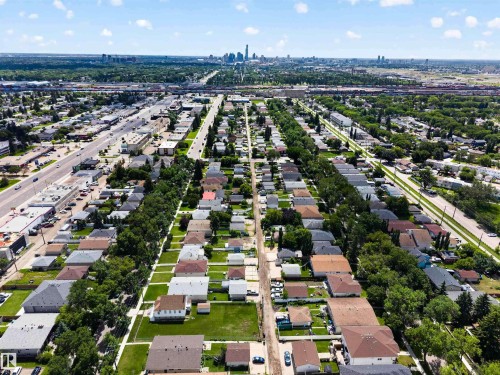 Aerial perspective showcasing an expansive residential area with a distant cityscape - 13156 101 St Nw, Edmonton, AB 