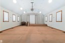 Spacious room featuring vaulted ceilings, recessed lighting, and a raised platform - 13156 101 St Nw, Edmonton, AB 