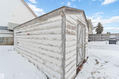Freestanding shed structure with wood-finish siding and a gabled roof - 13156 101 St Nw, Edmonton, AB 
