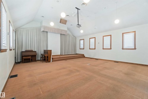 Expansive room featuring a tiered platform, high vaulted ceiling, and recessed lighting - 13156 101 St Nw, Edmonton, AB 