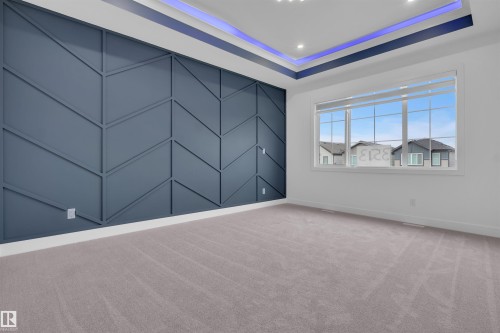 Accent wall featuring geometric paneling - 3604 44 Avenue, Beaumont, AB - Indoor Photo Showing Other Room