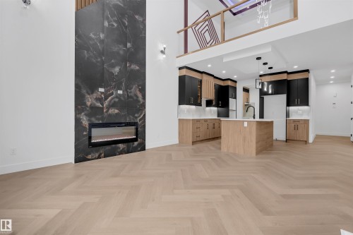 Herringbone wood-finish flooring throughout - 3604 44 Avenue, Beaumont, AB - Indoor With Fireplace
