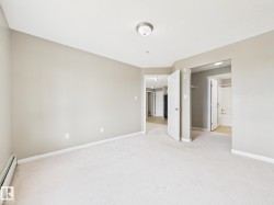 Carpeted interior space featuring light neutral wall paint - 