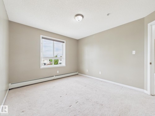 Neutral-toned walls complement the light-colored carpet flooring - #309 5350 199 St Nw, Edmonton, AB 