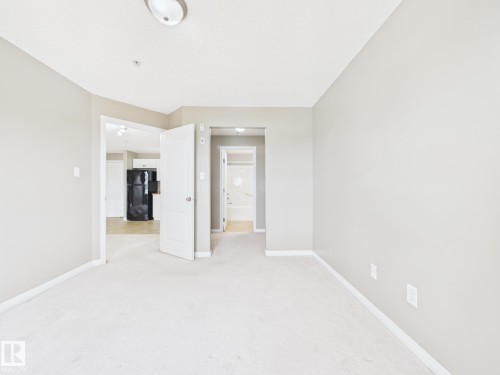 Neutral wall paint, white trim, and light-colored carpeting - #309 5350 199 St Nw, Edmonton, AB 