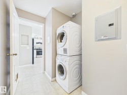 Dedicated laundry area featuring stacked front-loading appliances - 