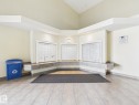 Main entrance featuring tiled flooring, a built-in mail center with three banks of mailboxes, and recessed lighting - #309 5350 199 St Nw, Edmonton, AB 